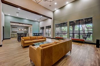 a living room with couches and a glass table    and a kitchen at Ventana Oaks Apartments, Texas, 78717